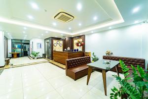 a lobby with a couch and a table at MELANTA HOTEL FLC SẦM SƠN in Sầm Sơn +83 photos