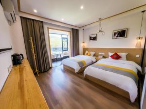 Postel nebo postele na pokoji v ubytování 372 Jingjing's Home Inn