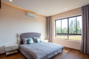 a bedroom with a bed and a large window at Pooler Property in Hua Hin +33 photos