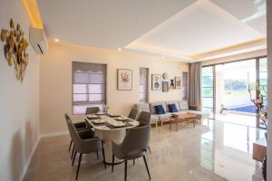 a dining room and living room with a table and chairs at Pooler Property in Hua Hin