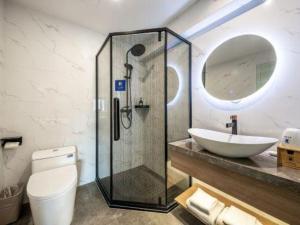 a bathroom with a shower and a sink and a toilet at Super 8 Hotel Xiamen Railway Station in Xiamen
