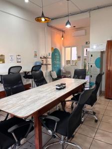 a conference room with a large wooden table and chairs at Casa Losodeli & Coworking- Adults Only in Puerto Escondido