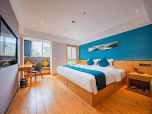 a hotel room with a bed and a table and chairs at Xian Katie Eastman Hotel in Xi'an +247 photos
