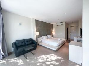 a bedroom with a bed and a couch and a chair at Ban Nai Amphoe in Nakhon Ratchasima +84 photos