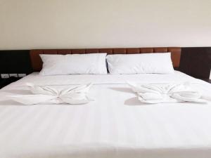 Una cama blanca con dos almohadas blancas. en Karimun City Hotel, en Tanjung Balai Karimun