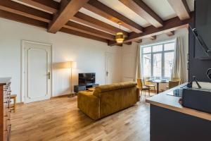 a living room with a couch and a table at Hôtel Lefort - L'Oasis Urbaine in Guingamp
