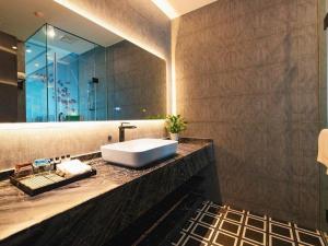 a bathroom with a sink and a large mirror at Xana Hotelle·Hotel Luzhou Baizitu Square in Luzhou +196 photos