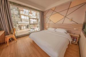 Ένα ή περισσότερα κρεβάτια σε δωμάτιο στο 7 Days Premium Qingdao World of Ocean Qingdao University