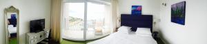 a bedroom with a bed and a large window at Apartments Villa Manda in Novi Vinodolski
