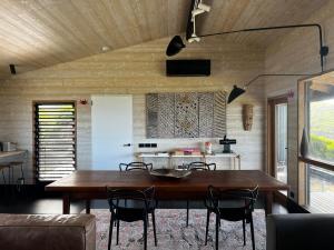a dining room with a wooden table and chairs at Admirals Cabin in Currie