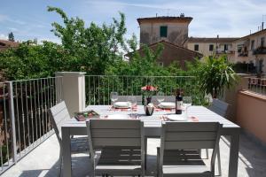 a white table and chairs on a balcony at YOURHOMEINLUCCA La Terrazza in Lucca