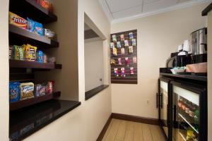 a room with a refrigerator and shelves with food at American Inn of Bethesda in Bethesda