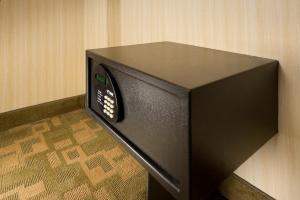 a black microwave oven sitting on top of a floor at American Inn of Bethesda in Bethesda