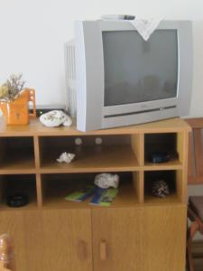 a television sitting on top of a wooden entertainment center at Jagoda Apartments in Zaostrog