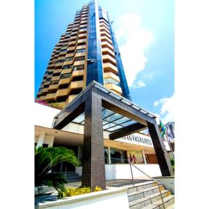 a tall skyscraper with a staircase in front of a building at 958 Golden Flat Fortaleza in Fortaleza +5 photos