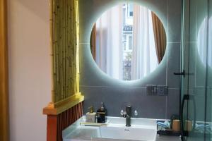 a bathroom with a sink and a mirror at Huaqi Country House B&B in Dali Shuanglang +73 photos