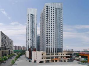 two tall skyscrapers in a city with buildings at Vienna Hotel Chengdu North Railway Station North Square Wukuaishi Metro Station in Chengdu