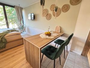a room with a table and chairs and a bed at Bohemian Chic Sage Dreams - Munich Central Station in Munich