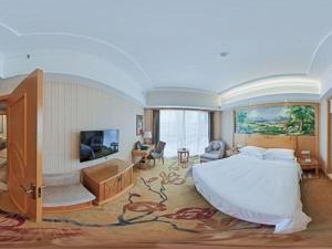 - une grande chambre avec un grand lit et une télévision dans l'établissement Vienna Hotel Hunan Yueyang Linxiang, à Yueyang