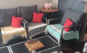 a room with a couch and two chairs and a table at AT Home in Burgas +11 photos