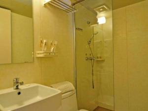 a bathroom with a shower and a toilet and a sink at Super 8 Hotel Guiyang Qianling Park Ruijin North Road in Guiyang +56 photos