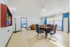 a dining room with a table and chairs and a couch at Yue Lai Yue Hotel in Guangzhou