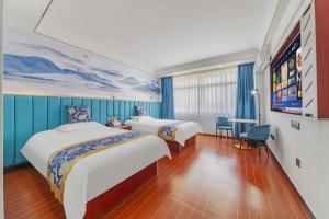 a hotel room with two beds and a flat screen tv at Yue Lai Yue Hotel in Guangzhou +242 photos