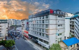 a building with writing on the top of it on a city street at Borrman Hotel Guilin Two Rivers and Four Lakes Beiji Plaza in Guilin