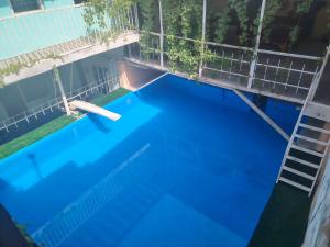 an overhead view of a blue swimming pool with a ladder at Historic house in Samarkand