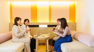 a group of women sitting around a table with drinks at Hotel Dream Gate Maihama in Chiba