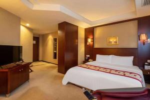 a bedroom with a large bed and a flat screen tv at Ramada by Wyndham Wujiaochang Shanghai in Shanghai +73 photos