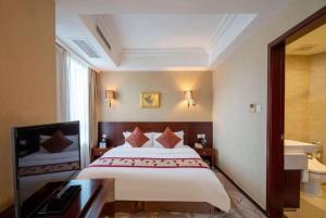 a hotel room with a large bed and a bathroom at Ramada by Wyndham Wujiaochang Shanghai in Shanghai +23 photos