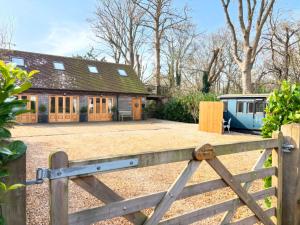 a wooden fence in front of a house at Hideaway carriage in Coltishall