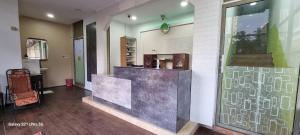 a lobby with a counter in the middle of a building at Zahaar KN Inn in Batu Ferringhi