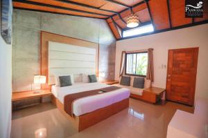 a bedroom with a large bed and a window at Panwana Resort in Rayong +179 photos