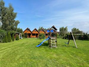 a playground in a yard with a house at Morskie Opowieści in Mikoszewo