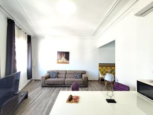 a living room with a couch and a table at Enjoy this apartment, with two bedrooms in Sant Adria de Besos