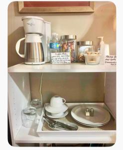 a kitchen shelf with a sink and utensils at Grande Lux Room- Boutique Hotel Style-15mins to NYC in Englewood