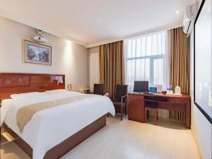 a hotel room with a bed and a desk with a computer at GreenTree Inn Beijing Tonzhou Maju Bridge No.2 Express Hotel in Majuqiao +186 photos