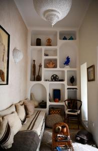 a living room with a couch and some shelves at Riad Bacha Beldi in Marrakech