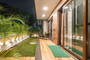 グルガオンにあるTIM Sector 51, ARTEMIS HOSPITAL 1 min walk, FORTIS & MEDANTA 4 mins driveの芝生と鉢植えのある屋外パティオ