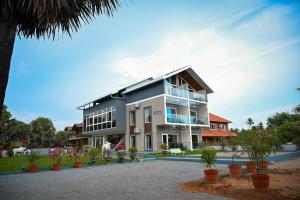 a large building with plants in front of it at Karkera's Beach Stay in Malpe