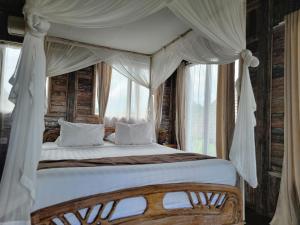 Postel nebo postele na pokoji v ubytování Ananda JJ Ubud Resort & Spa