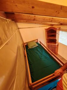 a person standing in a tent with a green bed at Yachting lodge 83 in Sanary-sur-Mer
