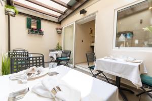 a restaurant with tables and chairs on a balcony at Heritage Hotel Antique Split in Split