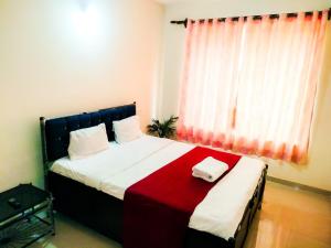 a bedroom with a bed with two towels on it at Safron Modern Stay at Varca, Goa in Varca