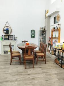 a dining room table and chairs in a store at Homestay Lilo Lila in Purwosari