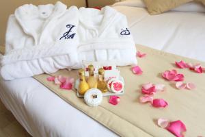 a bed with towels and flowers on it at Mengo Palace Hotel in Rio de Janeiro