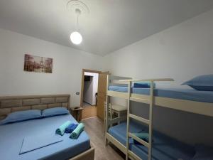 a bedroom with two bunk beds and a ladder at Vila Brilant in Vlorë