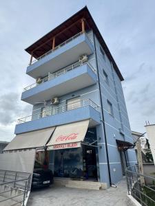 a building with a car parked in front of it at Vila Brilant in Vlorë
